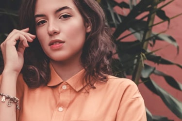 Female model wearing a short sleeved cotton shirt in orange